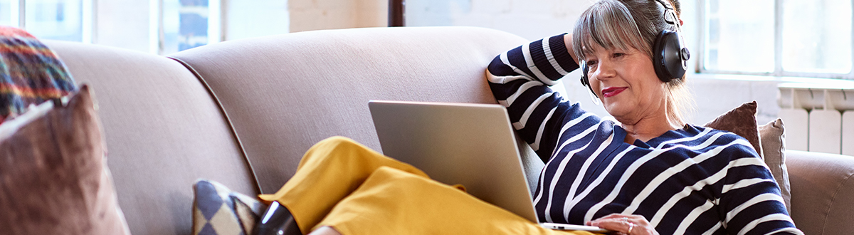 Woman on her laptop researching social research solutions relevant to TV and streaming measurement.