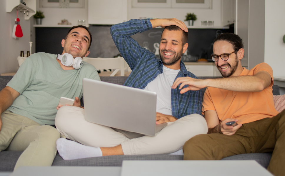 A group of friends streaming a movie and laughing whose data will be collected via ERS's streaming measurement solution.