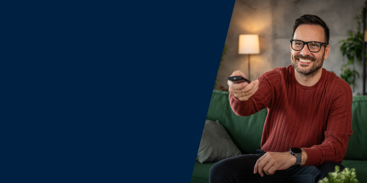 Male laughing and watching TV whose data will be collected via ERS's television field and survey research solution.