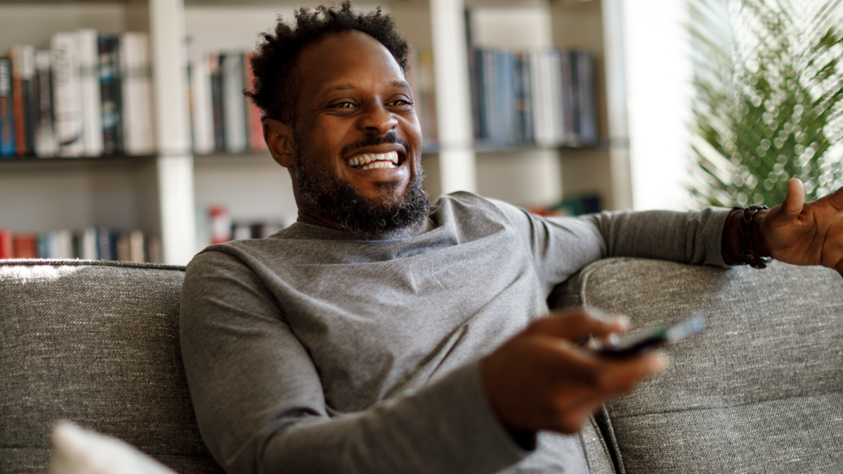 Male using his remote to look through channels whose data will be collected via ERS's linear tv measurement.